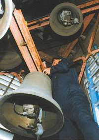 photo of Alex Masiarchin working on bells at Bishop O'Connor Catholic Pastoral Center